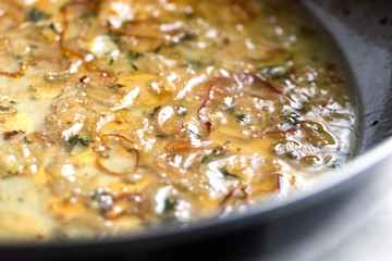 Close up of shallots braised in white wine