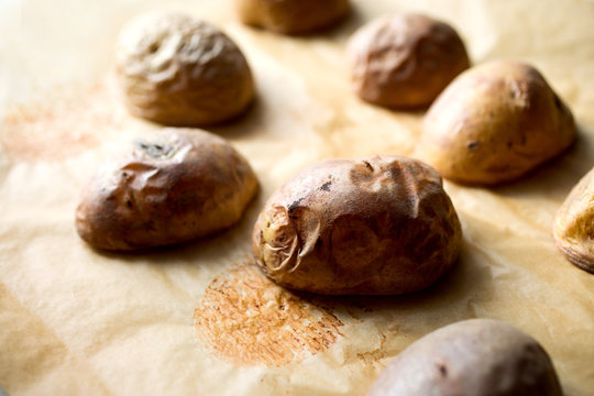 Close up of baked potato on parchment paper