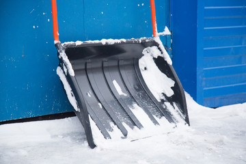 Clearing snow with a shovel in the winter on the street