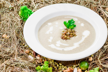 cream soup in a white plate. Healthy food delivery. Take away for diet. Fitness nutrition, vegetables, meat and fruits in eco boxes. at wood and straw with copy space. series of photos