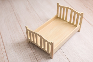 Fototapeta na wymiar little bed. crib for newborn photo shoot. children's bed. bed for dolls