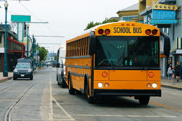 Beautiful school bus in the foreground on a cloudy day