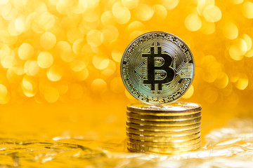 bitcoin coins on a gold background