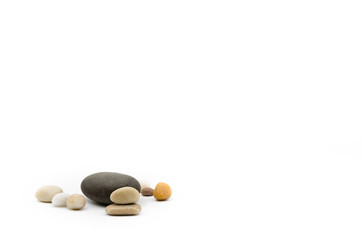 Assorted pebbles on white background