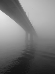 A long car bridge in the fog in the morning.