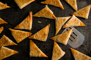 Close up of tiropita roasting on baking tray 