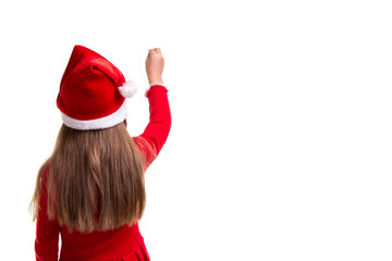 Rear view of a christmas girl with a raised hand up ready to write on the white isolated background