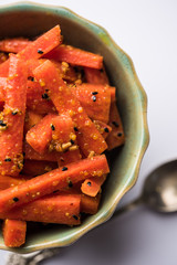 Carrot Pickle / Gajar ka Achar or Loncha in hindi. Served in a bowl over moody background....
