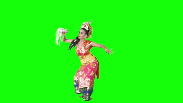 Balinese female dancer performing artistic dance in colorful costume. Shot in 4K over green screen