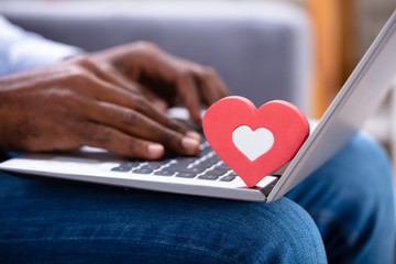 Heartshape On Keypad While Man Using Laptop