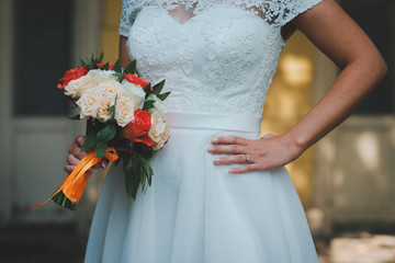 wedding bouquet in hands of bride