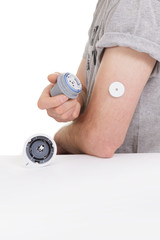 Fototapeta premium sensor diabetes checkup glucose man system sugar monitoring scan test hand skin medicine syringe table white background