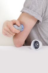 Fototapeta premium sensor diabetes checkup glucose man system sugar monitoring scan test hand skin medicine syringe table white background