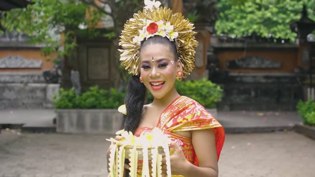 Closeup of beautiful Balinese woman laughing and smiling at camera. Shot in Bali, Indonesia in 4K format