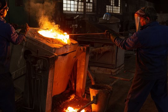 Workers working in foundry workshop
