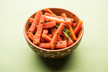 Carrot Pickle / Gajar ka Achar or Loncha in hindi. Served in a bowl over moody background....