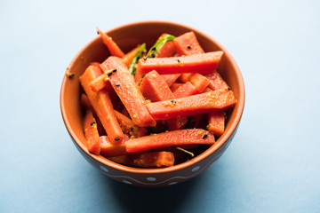 Carrot Pickle / Gajar ka Achar or Loncha in hindi. Served in a bowl over moody background....