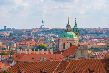 Fototapeta na wymiar View over historic center of Prague, St. Nicholas Church, red roofs of Prague, Czech republic