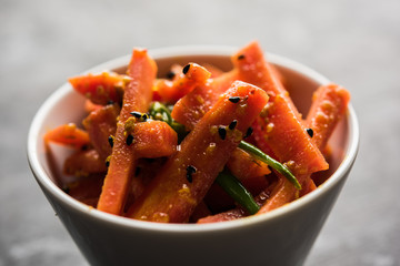 Carrot Pickle / Gajar ka Achar or Loncha in hindi. Served in a bowl over moody background....