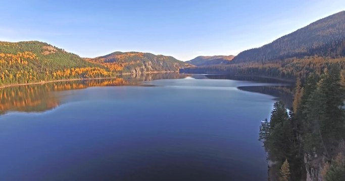Aerial shot of a Drone flying in and out of shot on a Lake in Montana in the Fall or Autumn