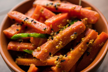 Carrot Pickle / Gajar ka Achar or Loncha in hindi. Served in a bowl over moody background....