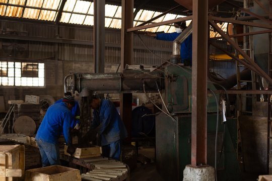 Workers in foundry working with molds