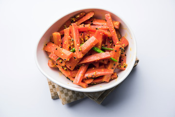 Carrot Pickle / Gajar ka Achar or Loncha in hindi. Served in a bowl over moody background....