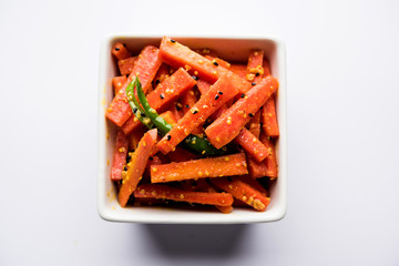 Carrot Pickle / Gajar ka Achar or Loncha in hindi. Served in a bowl over moody background....