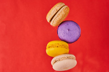Macaroni cake or almond cookies on red background. View in flight