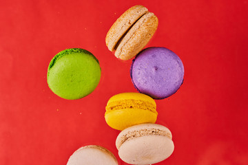 Macaroni cake or almond cookies on red background. View in flight