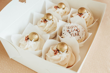 Obraz na płótnie Canvas festive dessert cupcakes with new year decor