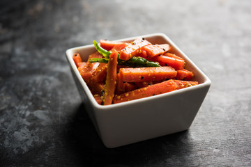 Carrot Pickle / Gajar ka Achar or Loncha in hindi. Served in a bowl over moody background....