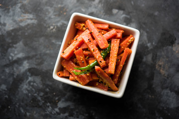 Carrot Pickle / Gajar ka Achar or Loncha in hindi. Served in a bowl over moody background....