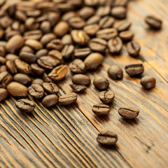 Coffee seeds on grunge wooden background close up