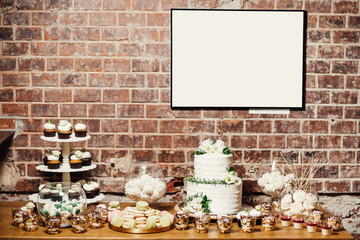 Wedding catering, table with modern desserts and cupcakes.