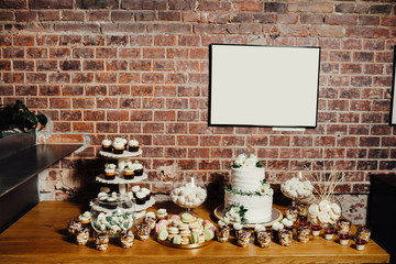 Wedding catering, table with modern desserts and cupcakes.