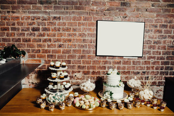 Wedding catering, table with modern desserts and cupcakes.