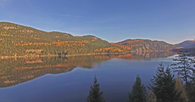 Aerial Drone shots of a Lake in Montana in the Fall or Autumn panning up pine trees