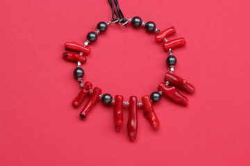 Jewelry made of coral natural stones on a red background