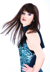 Fototapeta premium Fashionable young woman in pretty dress posing in the Studio.