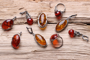 Jewelery from natural amber on a  wood texture background