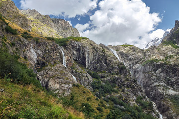 Fototapeta na wymiar Small mountain waterfalls Georgia Svaneti and Ushba summit