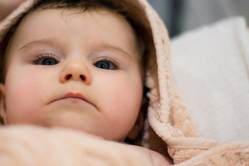 baby in towel after taking a bath