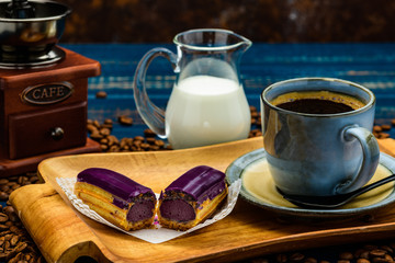 French coffee with cream and Eclair and coffee beans