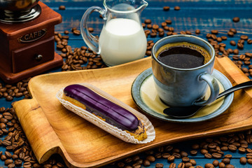 French coffee with cream and Eclair and coffee beans