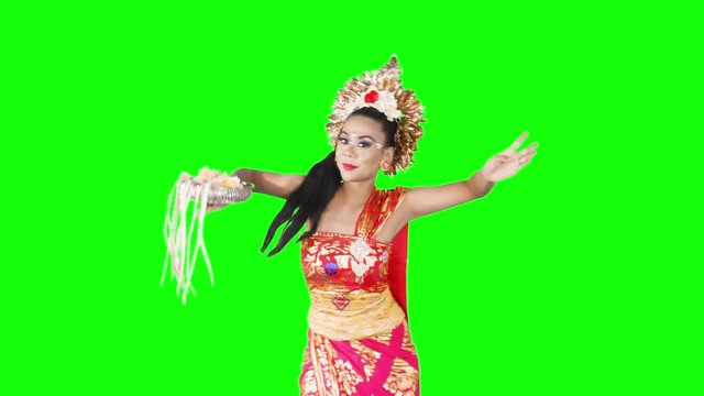 Balinese female dancer performing artistic dance in colorful costume. Shot in 4K over green screen