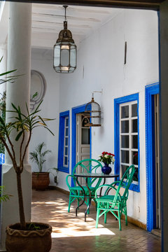 Patio with green chairs and blue framed windows