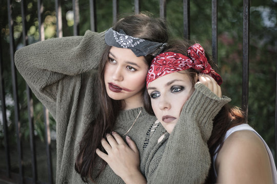 Portrait of two girls outdoors. The concept of difficult teenagers, bad students. Representatives of youth subcultures