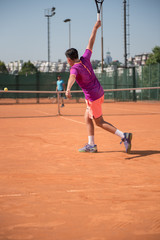 Young tennis player playing backhand