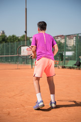 Young tennis player prepares for receiving the servis